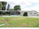 Ranch-style home with a carport and screened-in porch, nestled in a quiet neighborhood at 1476 Avenue F Ne, Winter Haven, FL 33881