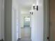 Hallway featuring wood flooring, sconce lighting, and views to other rooms at 1476 Avenue F Ne, Winter Haven, FL 33881