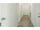 The hallway features wood look flooring, white trim, and white walls at 1476 Avenue F Ne, Winter Haven, FL 33881