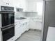 Well-equipped kitchen with sleek appliances, white cabinets, and plenty of counter space at 1476 Avenue F Ne, Winter Haven, FL 33881