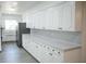 Spacious kitchen featuring ample white cabinetry, modern countertops, and stainless steel appliances at 1476 Avenue F Ne, Winter Haven, FL 33881