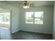 Inviting room with abundant natural light, featuring updated ceiling fan and gray wood-look flooring at 1476 Avenue F Ne, Winter Haven, FL 33881