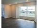 Sun-filled living room with a large picture window and modern gray wood-look floors at 1476 Avenue F Ne, Winter Haven, FL 33881