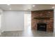 Spacious living room featuring a brick fireplace, recessed lighting, and gray wood-look flooring at 1476 Avenue F Ne, Winter Haven, FL 33881