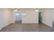 Open-concept living area boasting modern gray flooring, ceiling fans and updated paint at 1476 Avenue F Ne, Winter Haven, FL 33881