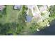 Aerial shot revealing the property's well-manicured lawn, mature trees, and private lake access at 15 Edwards Shrs, Haines City, FL 33844