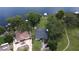 Aerial view showcases a lakefront property with lush greenery and serene waterfront access at 15 Edwards Shrs, Haines City, FL 33844