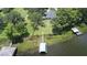 A lakefront property showcases its lush lawn, private dock, and tranquil access to the water at 15 Edwards Shrs, Haines City, FL 33844