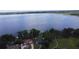 Aerial view of a lakefront house surrounded by mature trees and a sprawling body of water at 15 Edwards Shrs, Haines City, FL 33844