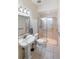 Clean bathroom featuring a walk-in shower, pedestal sink, and tiled floor at 15 Edwards Shrs, Haines City, FL 33844