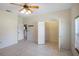 Bright bedroom featuring a ceiling fan, neutral walls, and a closet for ample storage at 15 Edwards Shrs, Haines City, FL 33844