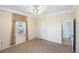 Bright bedroom with neutral carpet, ceiling fan, and access to an ensuite bathroom at 15 Edwards Shrs, Haines City, FL 33844