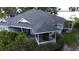 Aerial view highlighting the home's roof, back porch, and setting near the lake and surrounding greenery at 15 Edwards Shrs, Haines City, FL 33844