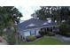 Aerial showcasing a charming home with a well-manicured lawn, lush landscaping, and a glimpse of the serene lake at 15 Edwards Shrs, Haines City, FL 33844