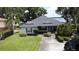 Aerial view showcasing a charming home near the lake, with lush landscaping and a well-maintained lawn at 15 Edwards Shrs, Haines City, FL 33844