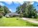 Lovely single-story home featuring beautiful trees and a wide open front yard at 15 Edwards Shrs, Haines City, FL 33844