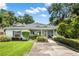 Charming single-story home featuring lush landscaping, a well-manicured lawn and a welcoming front entrance at 15 Edwards Shrs, Haines City, FL 33844