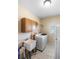 Convenient laundry room with washer, dryer, utility sink, and storage cabinets at 15 Edwards Shrs, Haines City, FL 33844