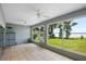 Sunroom showcasing tile floors and picturesque views of lush landscaping and a serene lake at 15 Edwards Shrs, Haines City, FL 33844