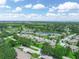 This aerial view shows the community surrounded by trees, a pond, and a golf course at 1507 Eagle Pond Dr # 1507, Winter Haven, FL 33884