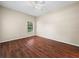 Bedroom with dark wood flooring, ceiling fan, and natural light at 1507 Eagle Pond Dr # 1507, Winter Haven, FL 33884