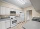 Bright kitchen with white cabinets, tile flooring, and neutral countertops at 1507 Eagle Pond Dr # 1507, Winter Haven, FL 33884