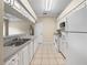 Bright eat-in kitchen featuring white appliances, cabinets and tile flooring at 1507 Eagle Pond Dr # 1507, Winter Haven, FL 33884