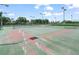 Well-maintained community tennis court surrounded by lush greenery and fencing at 1507 Eagle Pond Dr # 1507, Winter Haven, FL 33884