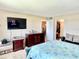 Comfortable bedroom featuring a bed, dresser, television, and closet space at 1776 6Th Street Nw # 709, Winter Haven, FL 33881