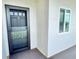 Condo unit entrance door with glass storm door and a window allowing natural light into the condo at 1776 6Th Street Nw # 709, Winter Haven, FL 33881