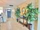 Inviting entryway featuring a console table with plants and a decorative mirror at 1776 6Th Street Nw # 709, Winter Haven, FL 33881