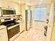 Bright kitchen with stainless steel appliances, tile floors, and ample cabinet storage at 1776 6Th Street Nw # 709, Winter Haven, FL 33881