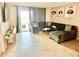 Stylish living room featuring a comfortable sectional sofa, TV, and access to the outdoor patio at 1776 6Th Street Nw # 709, Winter Haven, FL 33881