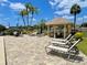 Relaxing pool area with lounge chairs, a gazebo, and lush tropical landscaping at 1776 6Th Street Nw # 709, Winter Haven, FL 33881