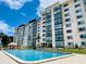 Resort-style pool with inviting blue water in front of a well-maintained condominium building at 1776 6Th Street Nw # 709, Winter Haven, FL 33881
