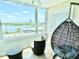 Sunroom featuring a hanging chair, table with chairs, and a large window with a scenic view at 1776 6Th Street Nw # 709, Winter Haven, FL 33881