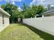 Fenced backyard featuring lush lawn, shade trees, and a playset, providing privacy and recreation at 1790 Turtle Rock Dr, Lakeland, FL 33803