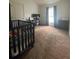 Bedroom with a crib, desk, and computer at 1790 Turtle Rock Dr, Lakeland, FL 33803
