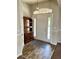 Inviting foyer with wood-look flooring, a rustic cabinet, and a decorative rug at 1790 Turtle Rock Dr, Lakeland, FL 33803