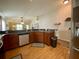 Functional kitchen layout with warm wood cabinets, a breakfast bar, and views into the living spaces at 1790 Turtle Rock Dr, Lakeland, FL 33803