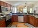 Well-equipped kitchen with wood cabinets, stainless steel appliances, and an open view to the living areas at 1790 Turtle Rock Dr, Lakeland, FL 33803