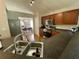 Modern kitchen with wood cabinetry, laminate countertops, stainless steel appliances, and an eat-in kitchen nook at 1790 Turtle Rock Dr, Lakeland, FL 33803