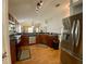 Well-lit kitchen with wood cabinets, stainless steel appliances, and view to the living room at 1790 Turtle Rock Dr, Lakeland, FL 33803