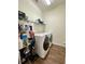 Well-equipped laundry room featuring modern washer and dryer, shelving and wood-look flooring at 1790 Turtle Rock Dr, Lakeland, FL 33803