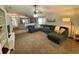 Open-concept living room with large sofa, neutral decor, and view of the kitchen at 1790 Turtle Rock Dr, Lakeland, FL 33803