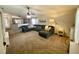 Inviting living room with carpet, large sofa, and view to the kitchen at 1790 Turtle Rock Dr, Lakeland, FL 33803