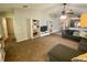 Spacious living room with a ceiling fan, white shelving unit, and view into the kitchen at 1790 Turtle Rock Dr, Lakeland, FL 33803