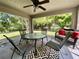 Relaxing screened porch with ceiling fan, comfortable seating, stylish rug, and ample natural light at 1790 Turtle Rock Dr, Lakeland, FL 33803