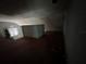 Unfinished attic room with a window and a Christmas tree at 1805 S Lake Reedy Blvd, Frostproof, FL 33843