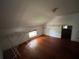 Attic room with hardwood floors and a window at 1805 S Lake Reedy Blvd, Frostproof, FL 33843